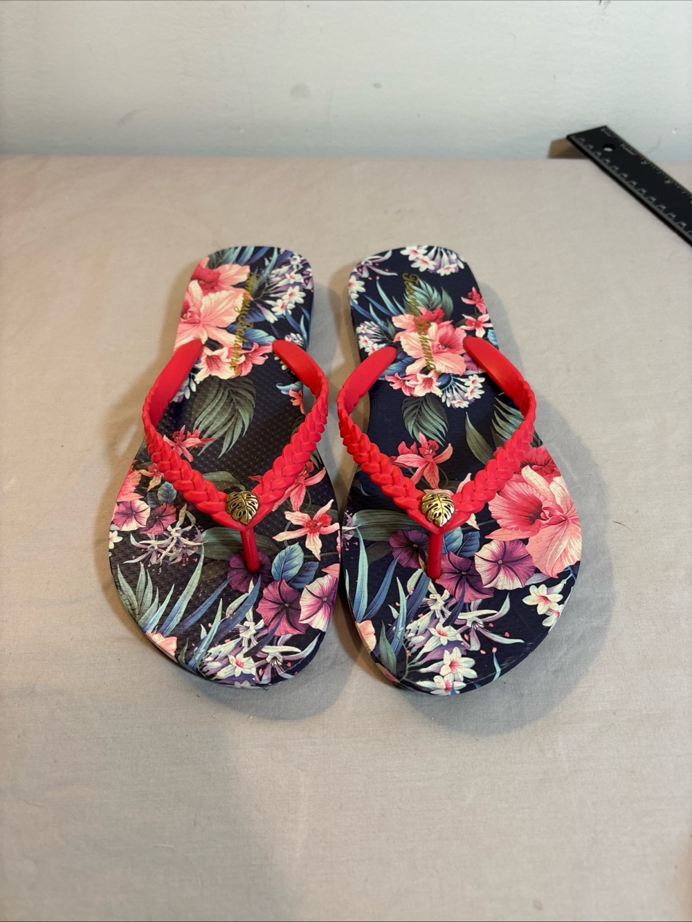 Tommy Bahama Women’s Floral Navy Flip Flops with Braided Red Straps